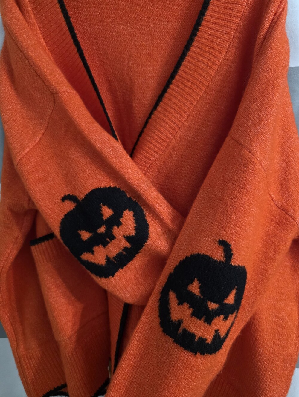 TALULAH Bright Orange Cardigan with Black Trim And Jack-o-Lantern Design